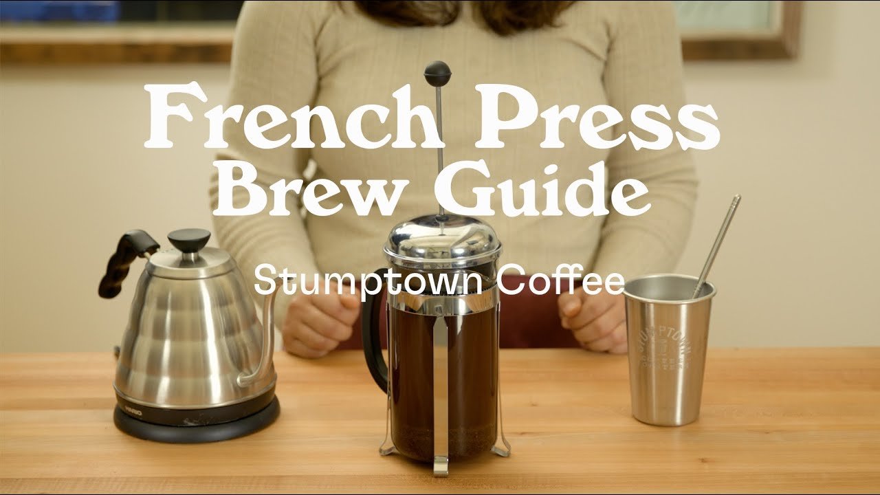 Close up of a French press filter showing the immersion brewing process.