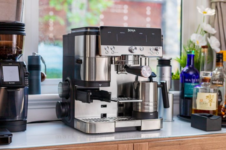 A minimalist home espresso setup with a Moka pot and coffee beans.