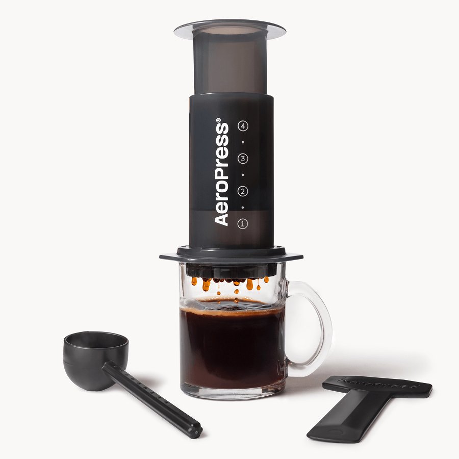 Unplugging a coffee maker power cord from the wall outlet for safety.